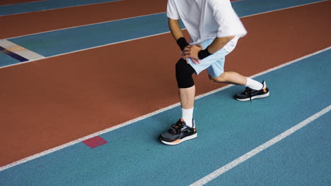 young man stretching indoors