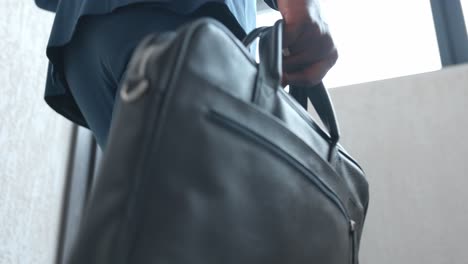 businessman carrying briefcase up stairs