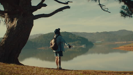 traveler admiring a serene lake landscape