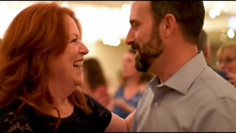 a joyful dance: capturing the heartfelt moments of a couple dancing together under glimmering lights, embracing each other with laughter and connection