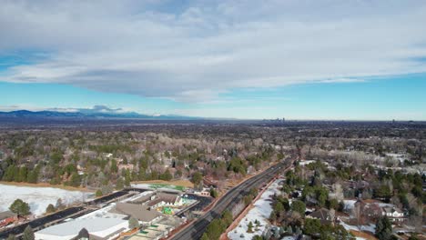 drone aerial view of a school with the denver, co skyline in the background