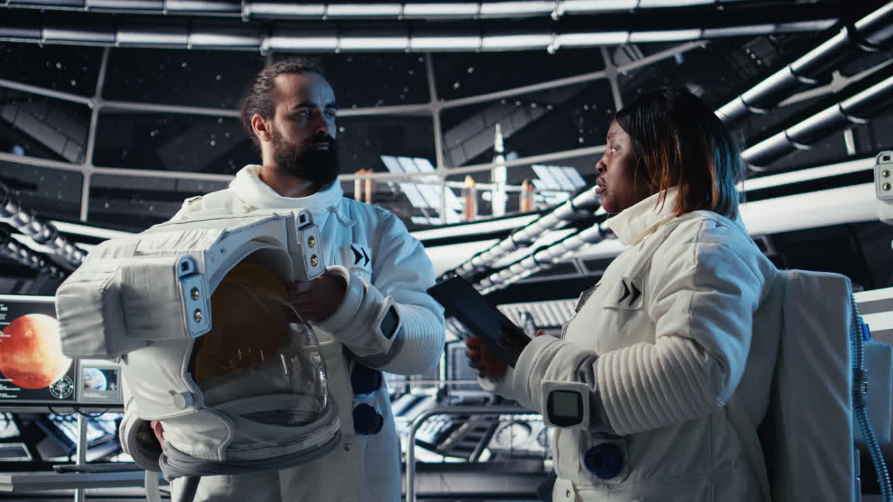 Astronaut getting mission briefing from leader before leaving space station