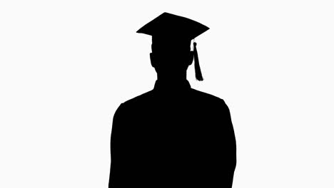 silhouette young male smiling graduate showing thumb up