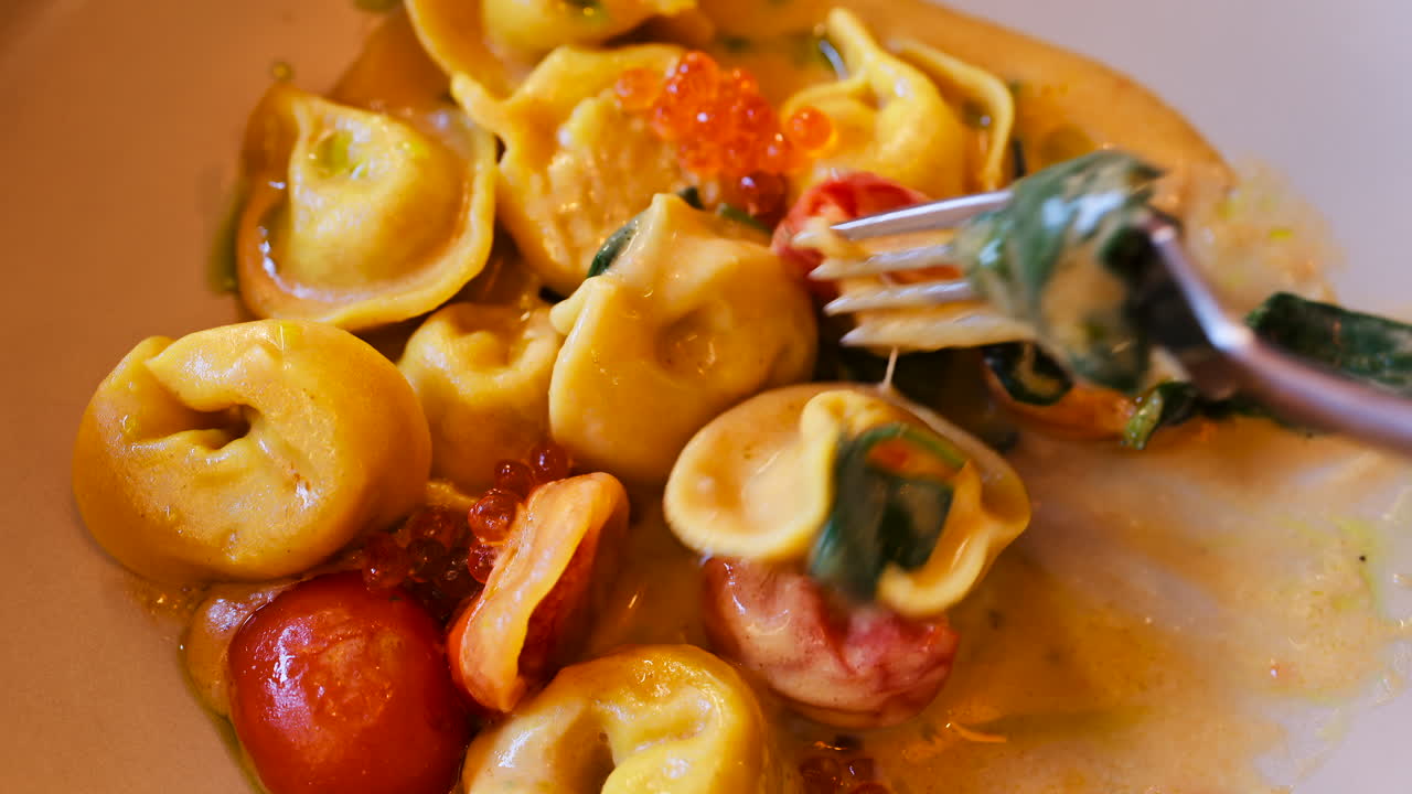 Close up of a ravioli dish with seafood and sauce at a restaurant