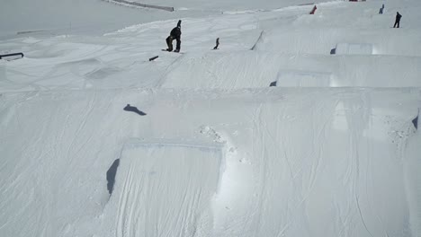 Snowboarder-jumping-on-kicker-making-540-degree-spin