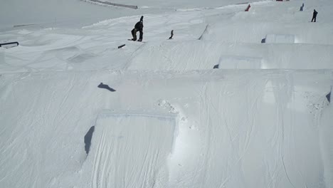 snowboarder jumping on kicker making 540 degree spin