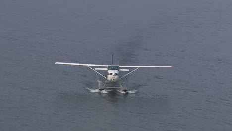 Toma-Aérea-Giratoria-De-Un-Hidroavión-Aterrizado-Que-Se-Dirige-A-La-Orilla-Del-Lago-De-Como,-Italia