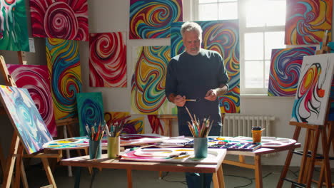 artist painting abstract art in a studio