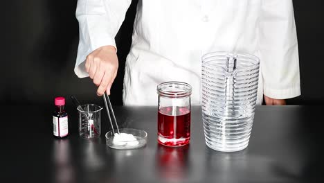 scientist conducts dry ice experiment with red liquid