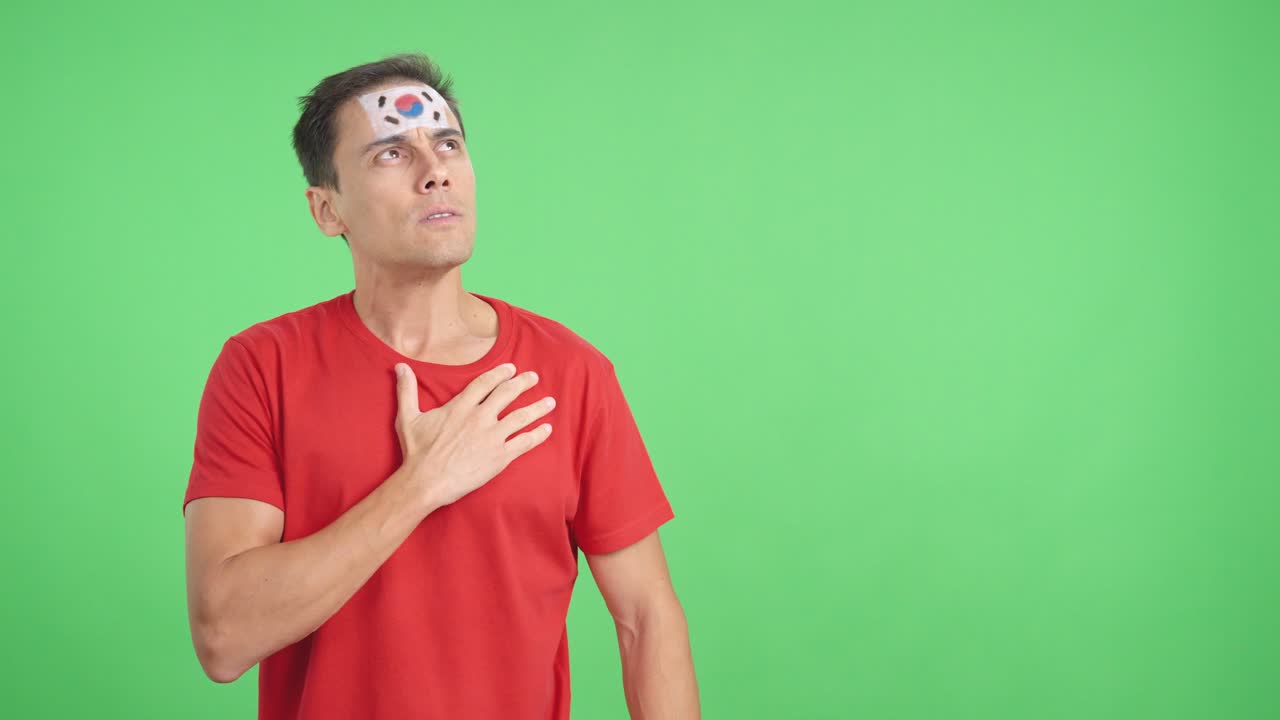 Man listening to the South Korea national anthem with solemnity