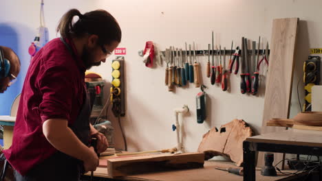 craftsperson in joinery using vice tool to clamp piece of wood