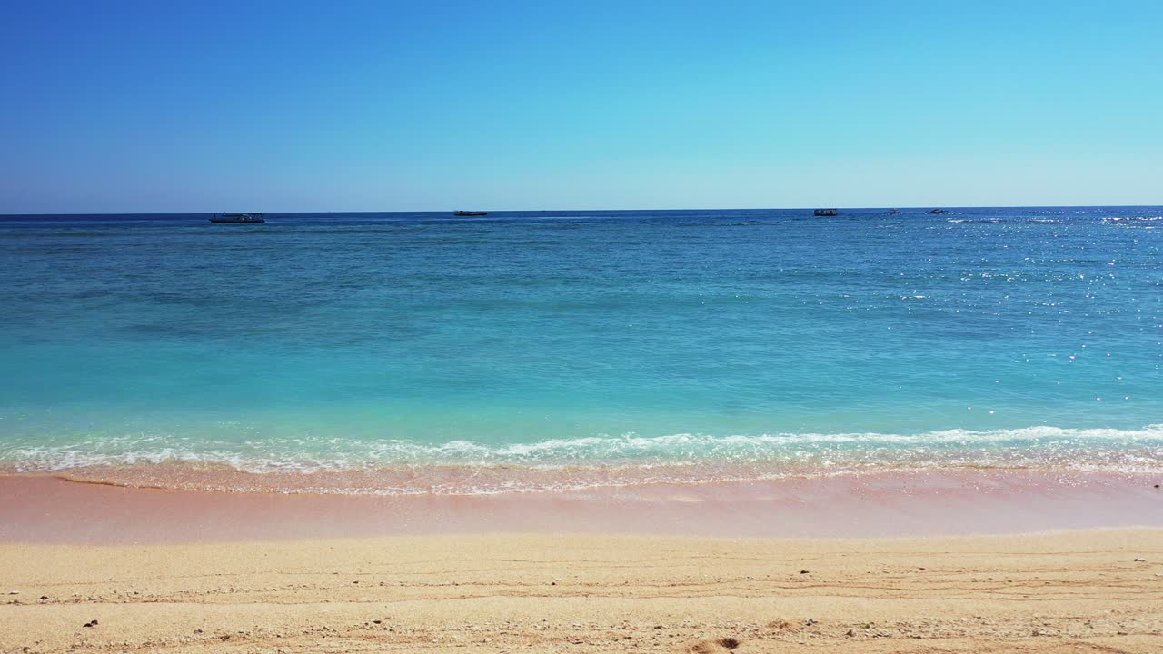 Panoramic seascape with aquamarine seawater waving on white sand of exotic beach with clear blue sky background in Fiji islands