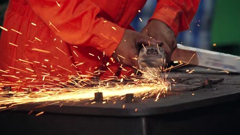 Professional-mechanic-is-cutting-steel-metal.