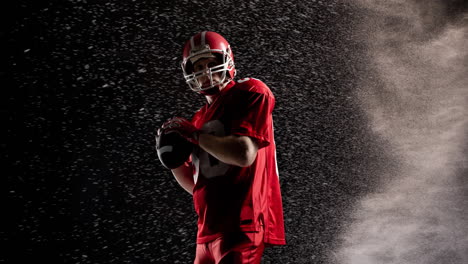 animation of portrait of american football player holding ball over white particles, on black