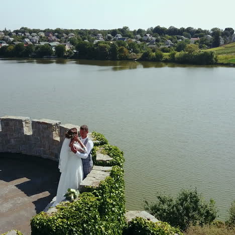 beautiful romantic wedding couple, groom and bride hugging in an old castle. destroyed ancient fortresses square video