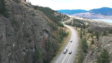 trans-canada highway 1 next to kamloops lake , west end towards savona in british columbia, canada on a overcast day in summer