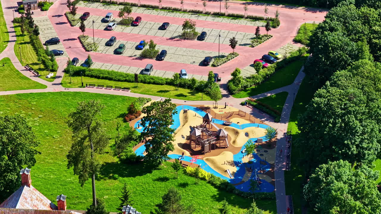Playground next to a parking lot in Birži, Lithuania. Aerial