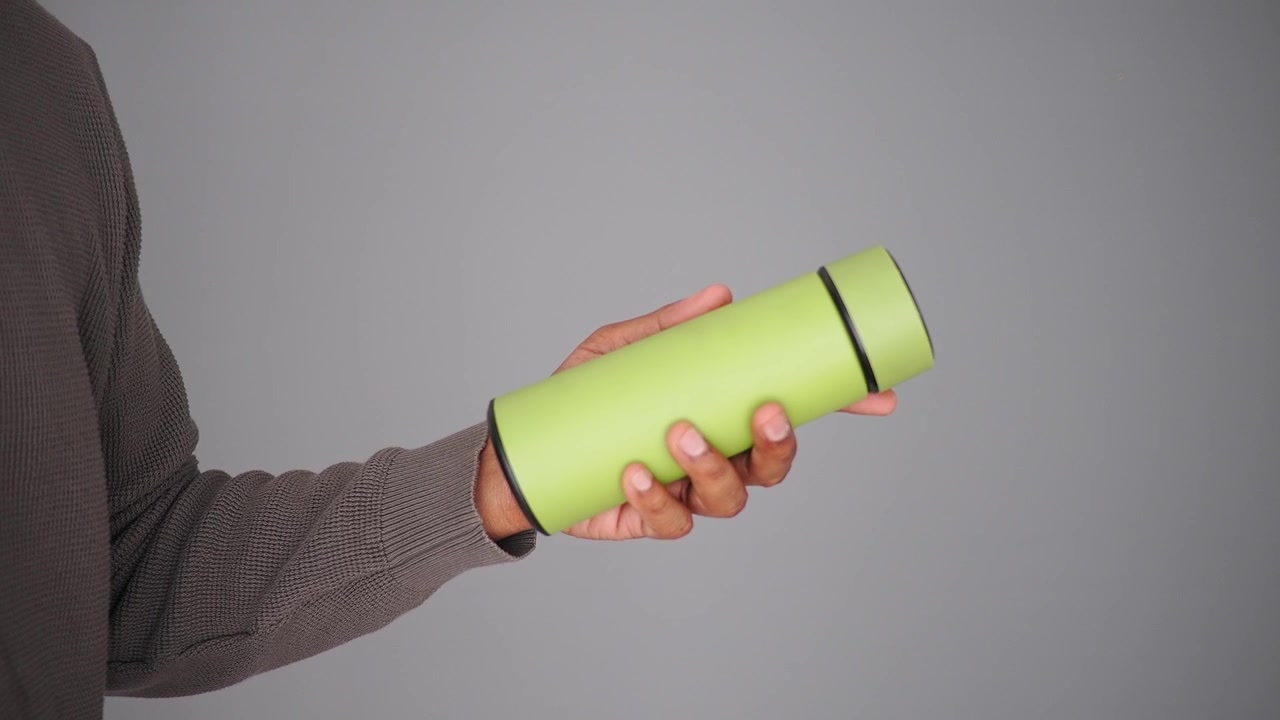 Person Holding a Green Reusable Water Bottle