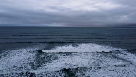 drone  waves crashing on the rocks, guincho beach on the horizon. cascais, portugal. aerial view winter coastal ocean line. the atlantic ocean near cabo da roca