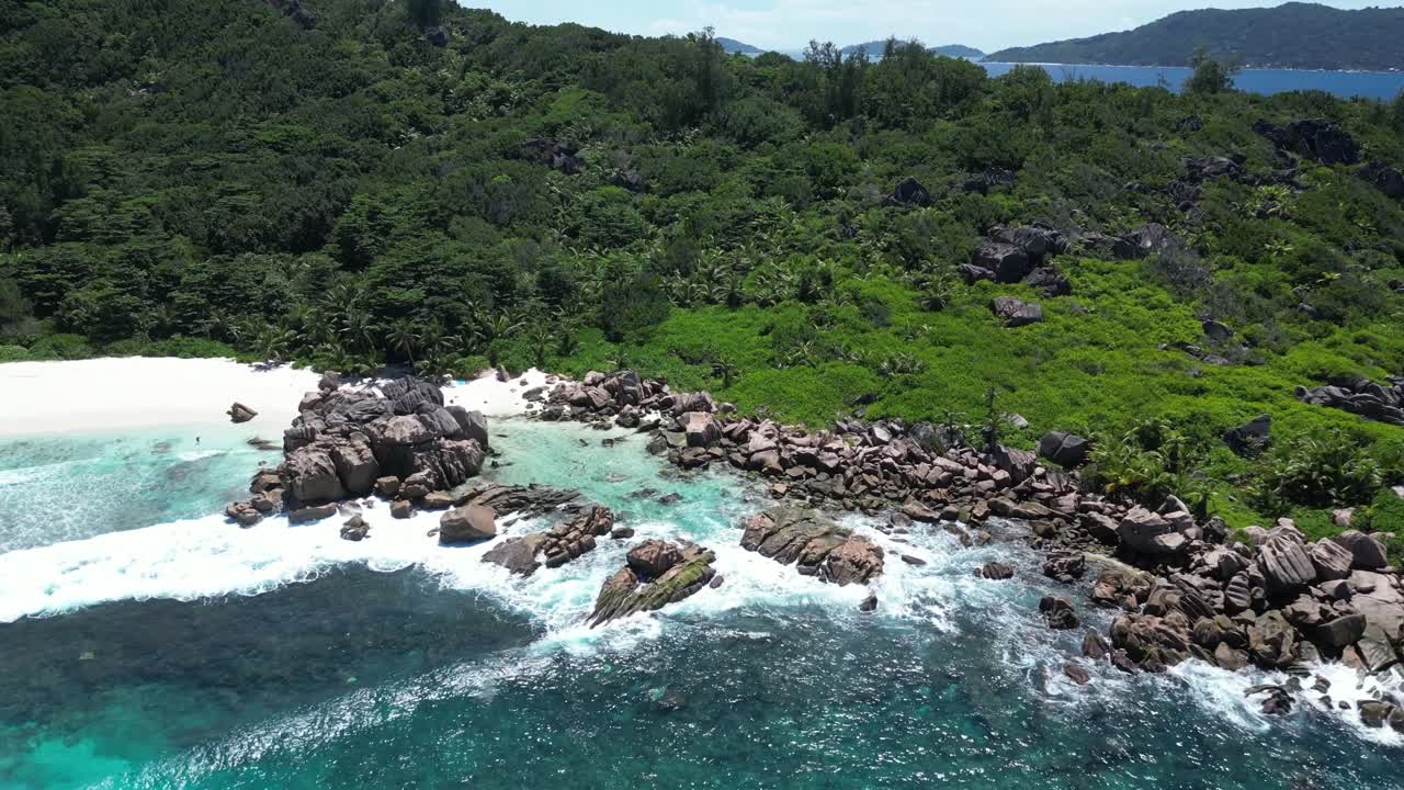 drone above white sand secluded solitary beach La Digue Island, Seychelles archipelago Indian Ocean, vacation relax chill meditative vibes aerial footage