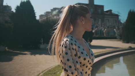 stylish young woman walking through the park.