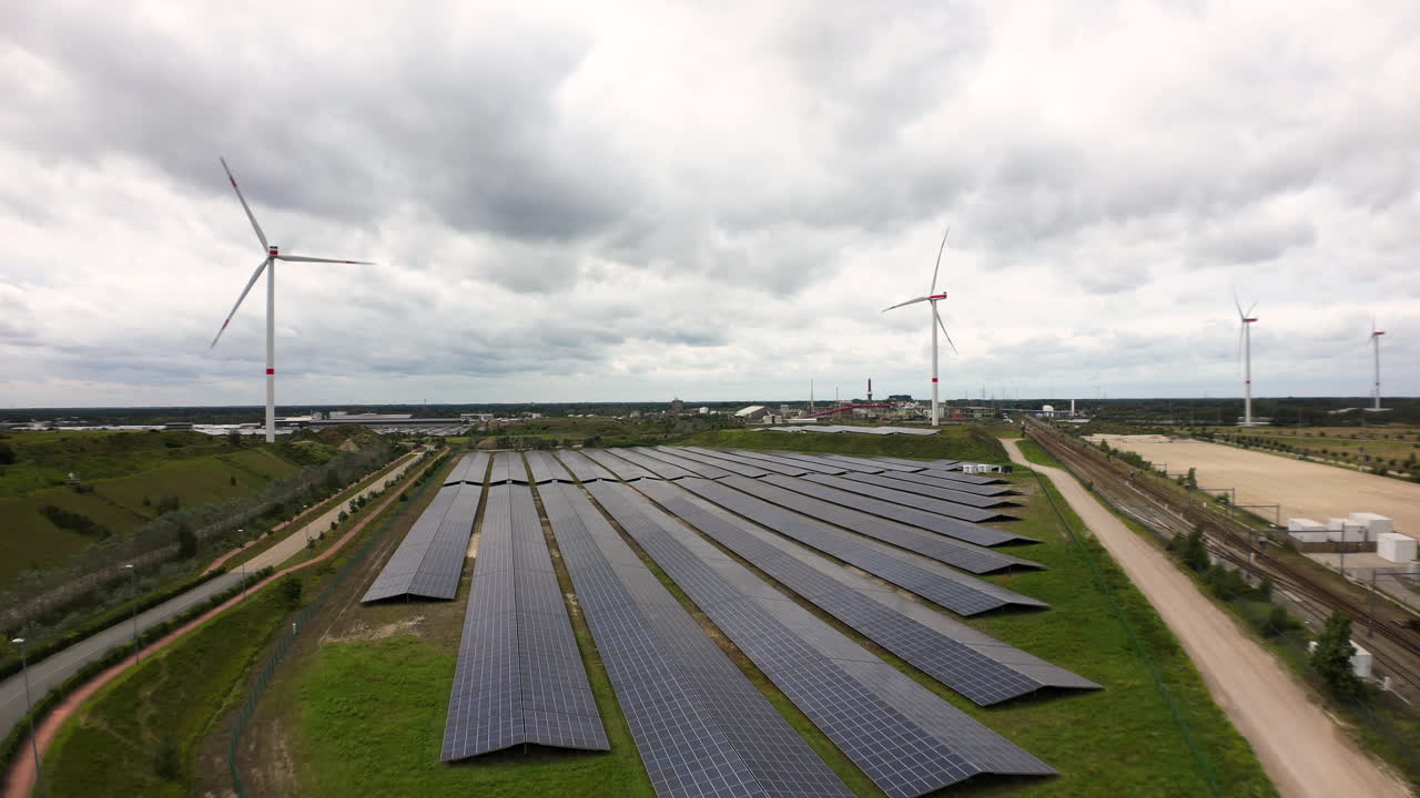 Green energy farm in Belgium fields, aerial descend view