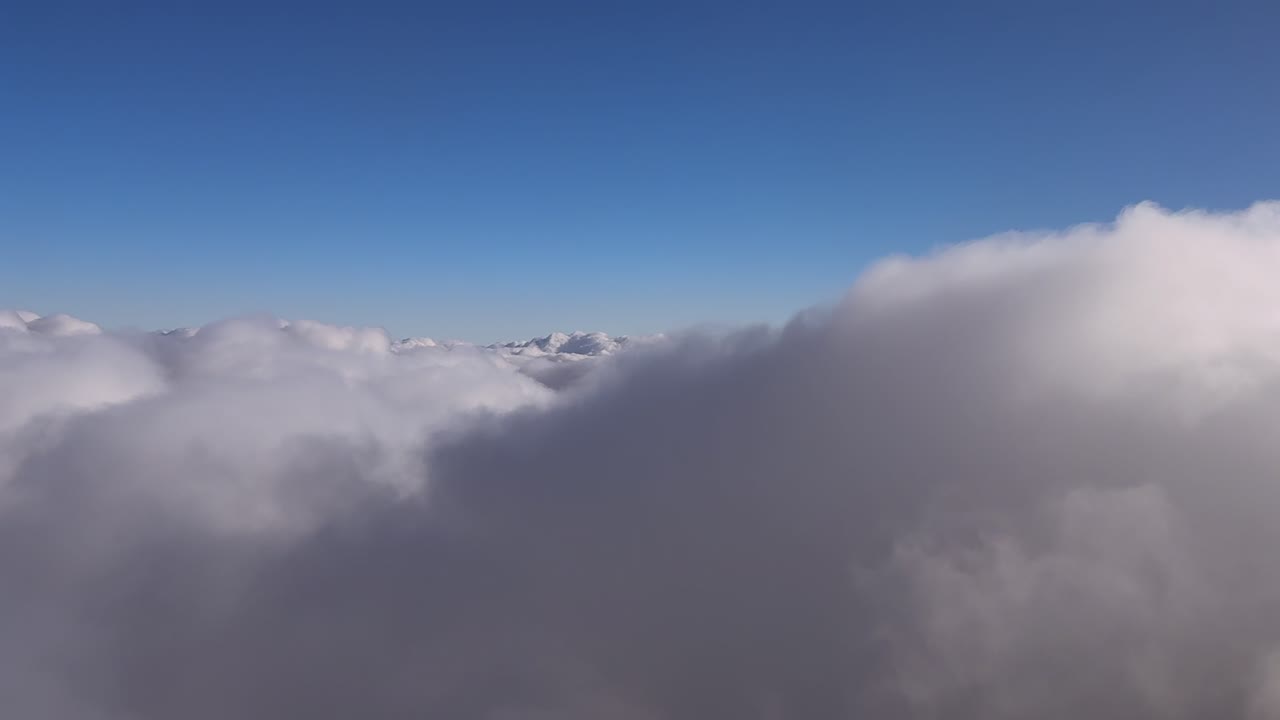An immersive cockpit view in a peaceful flight over an endless blanket of clouds recorded at the blue hour