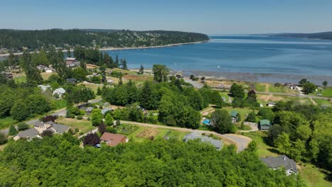 orbiting wide shot of freeland's neighborhoods near the holmes harbor waterfront