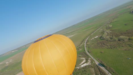 hot air balloons over rural landscape