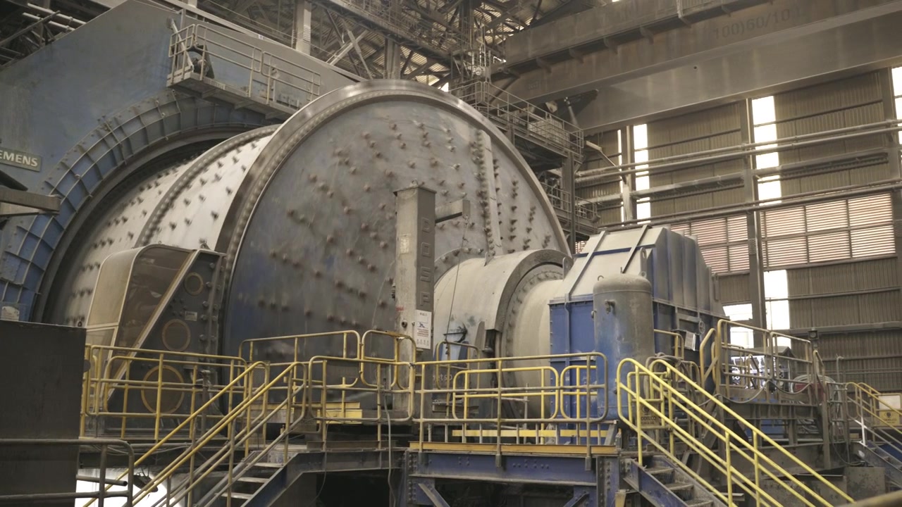 Massive SAG grinding mill operating inside a copper processing plant at El Teniente Mine in Chile. Industrial infrastructure used for mineral reduction and copper production.