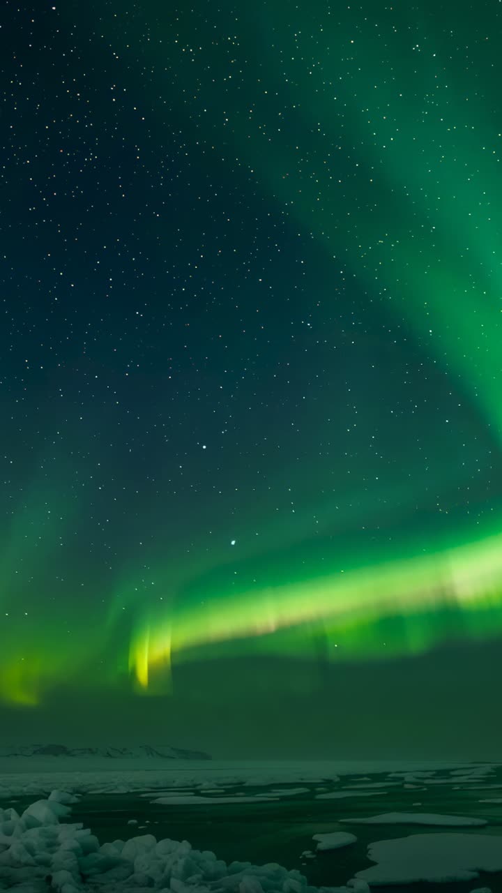 Vertical video: Solar wind hitting, lighting aurora, sweeping arc across icy plain with star field