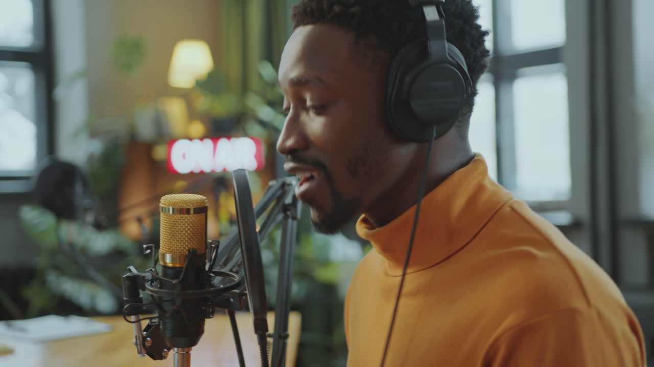 African American Blogger Recording New Episode of Audio Podcast