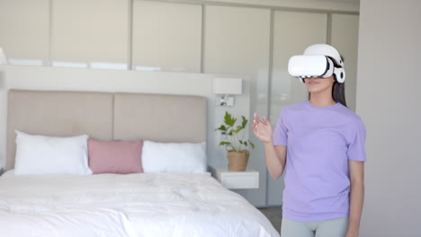 using vr headset, woman interacting with virtual environment in bedroom, copy space