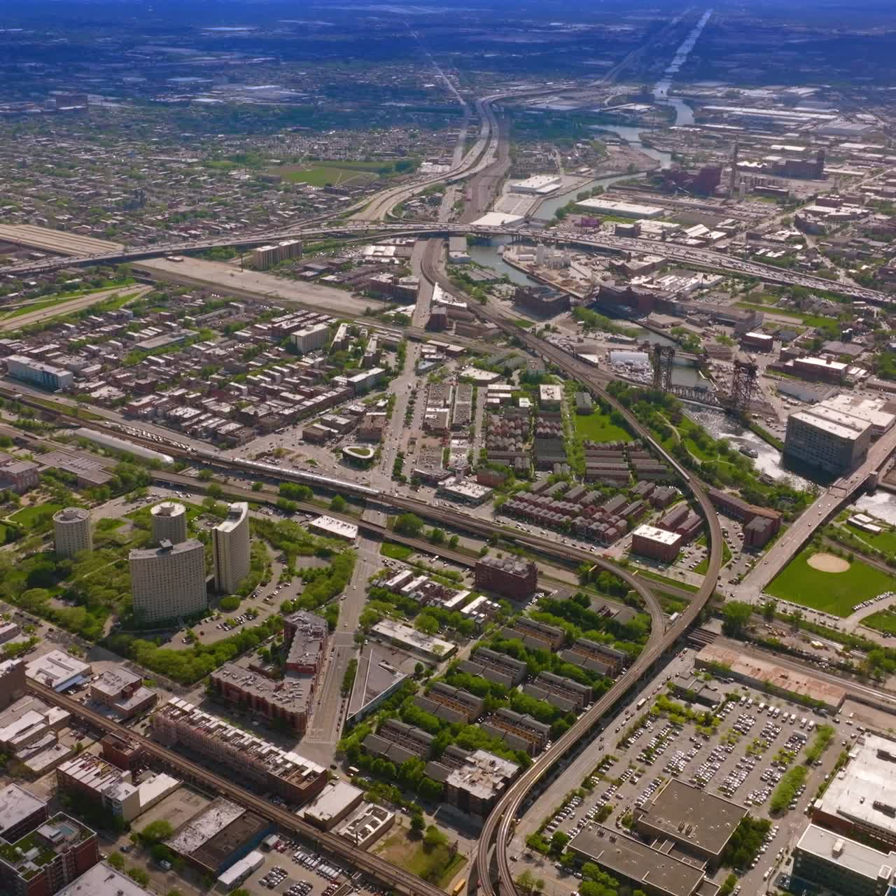 Extensive city scenery lined with numerous roads. Drone flying high over the metropolis on sunny day. Chicago, Illinois, USA