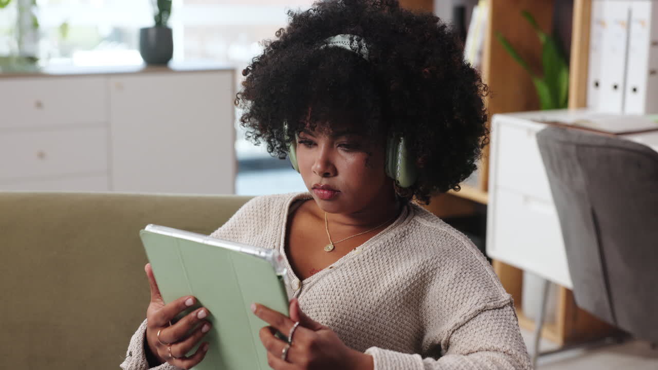 Woman using tablet with headphones