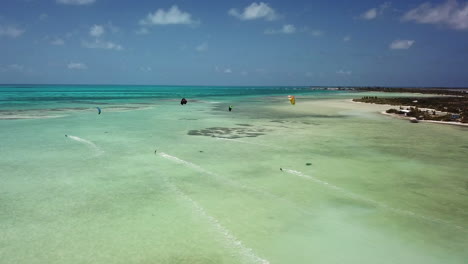 aerial of kite surfers in tropical blue ocean