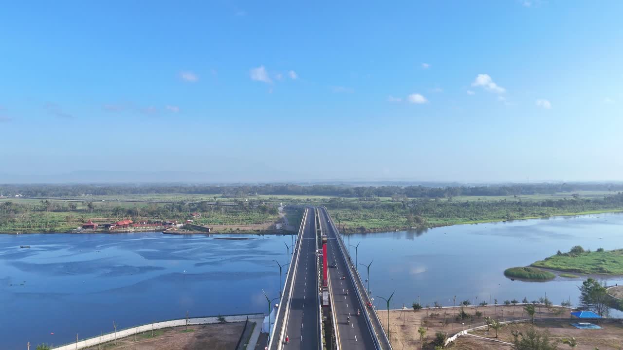 Modern highway bridge over river in Indonesia, aerial view