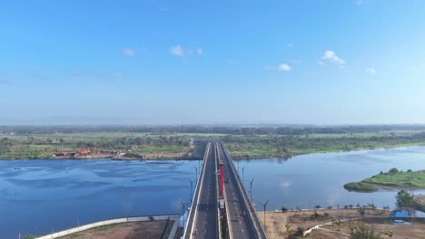 modern highway bridge over river in indonesia, aerial view