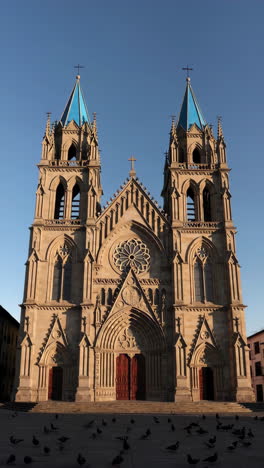 grand gothic cathedral with blue spires under a clear sky