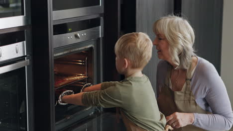 grandmother and grandson baking cupcakes together