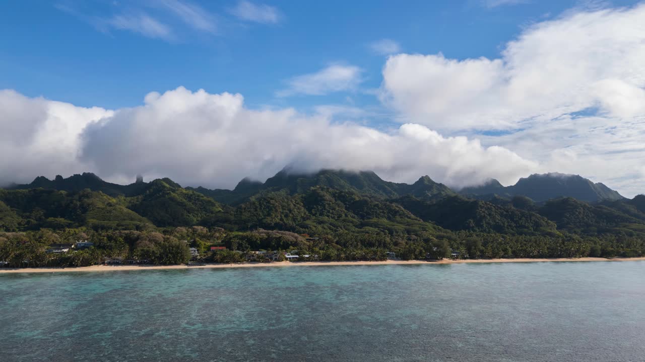 Flying Over The Blue Sea Towards The Te Rua Manga Mountain In The Cook Islands. - aerial hyperlapse