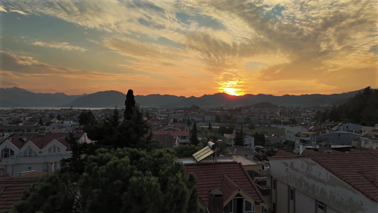 Stunning Sunset Over Coastal City with Mountains