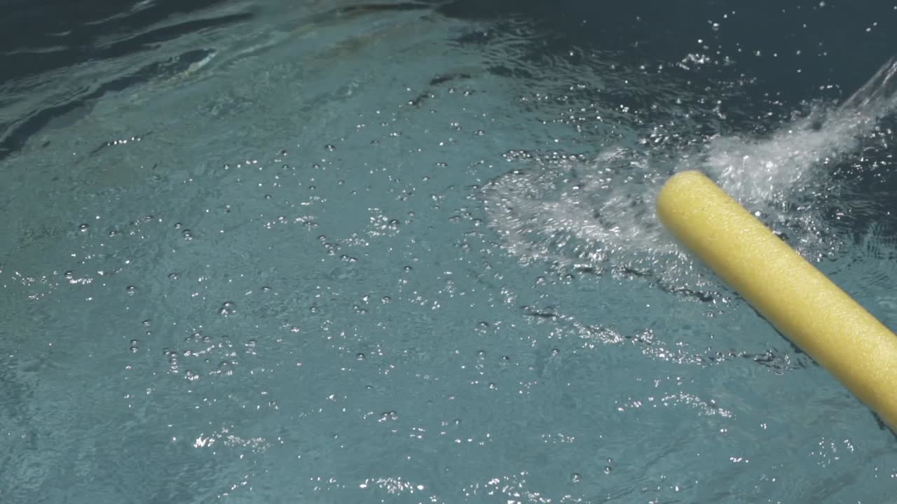 Water filling a pool, with floating tube with bubbles and impurities, indicating the need for cleaning and maintenance to ensure hygiene and enjoyment
