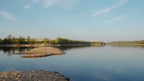 panning shot of riverbed after lowered water level in sunny summer evening