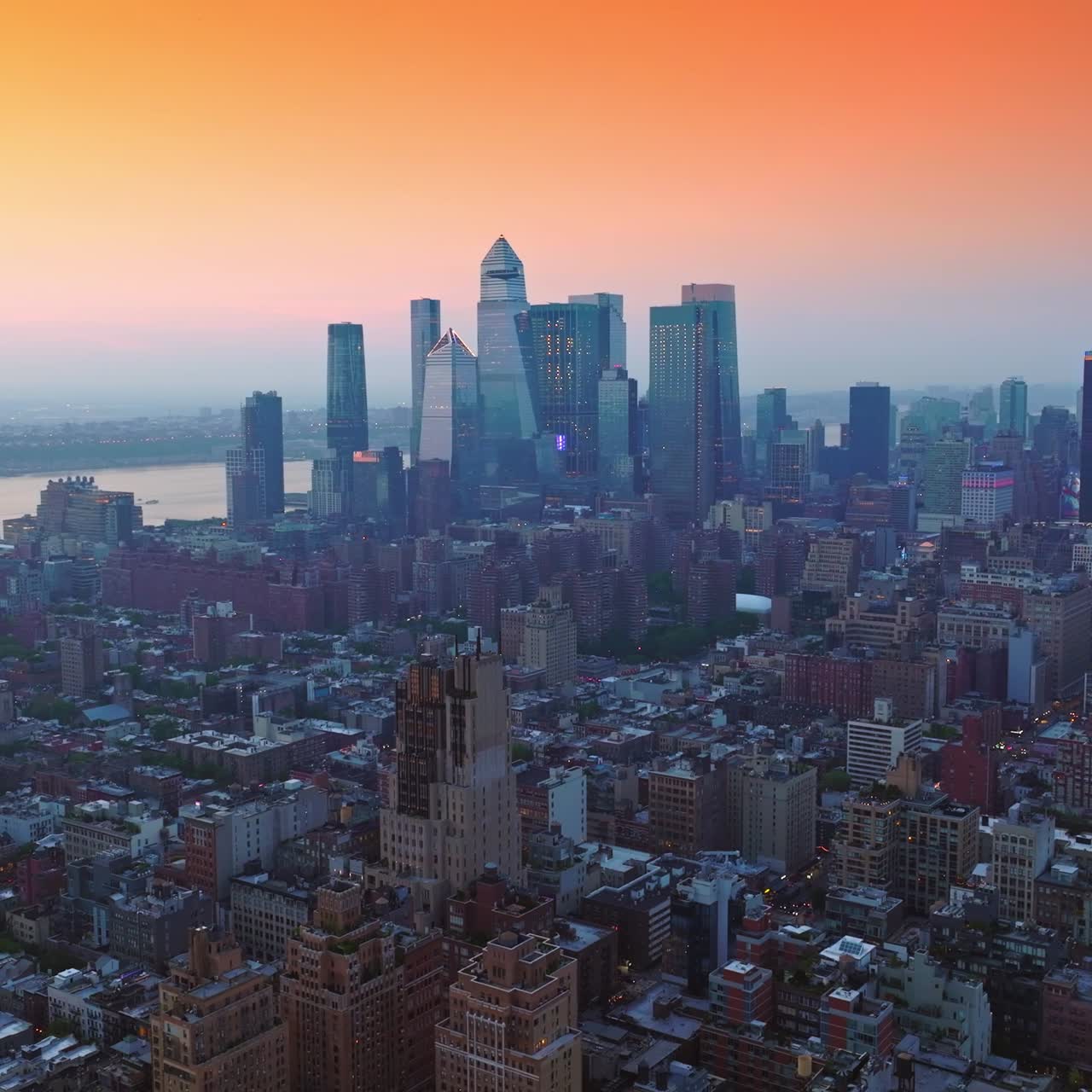 Rising over densely built cityscape of New York. Impressive architecture of excellent metropolis at the backdrop of pink sky