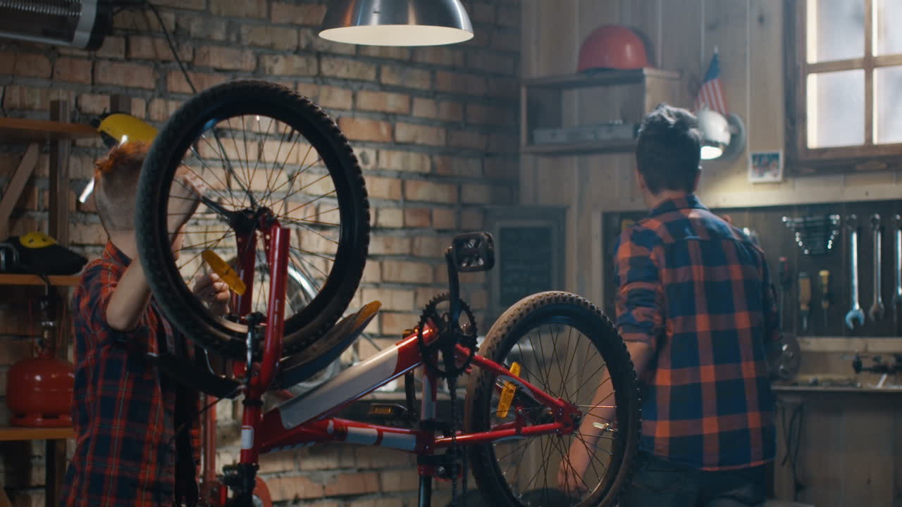 Kids Repairing a Bicycle in a Garage