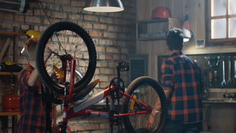 kids repairing a bicycle in a garage