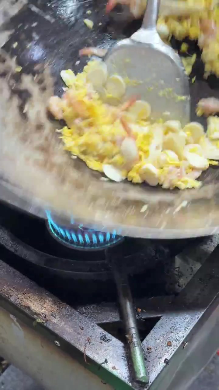 Chef Stir-Frying Ingredients in a Wok Over High Heat