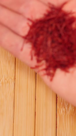 pouring saffron threads from hand