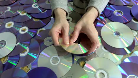 woman holding damaged cd and dvd disc